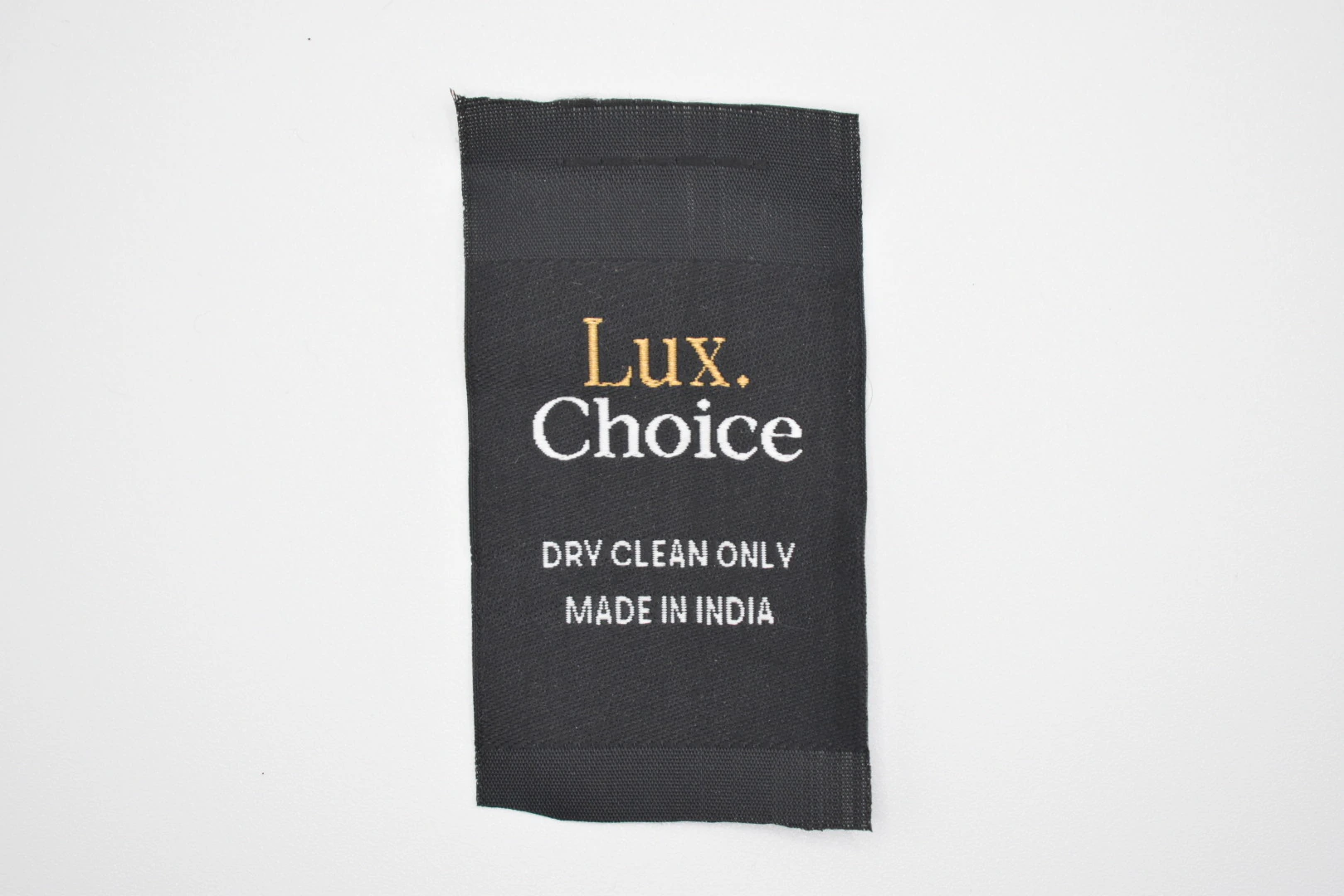 Lux Choice centre-fold woven brand label — front view, premium woven clothing label sample