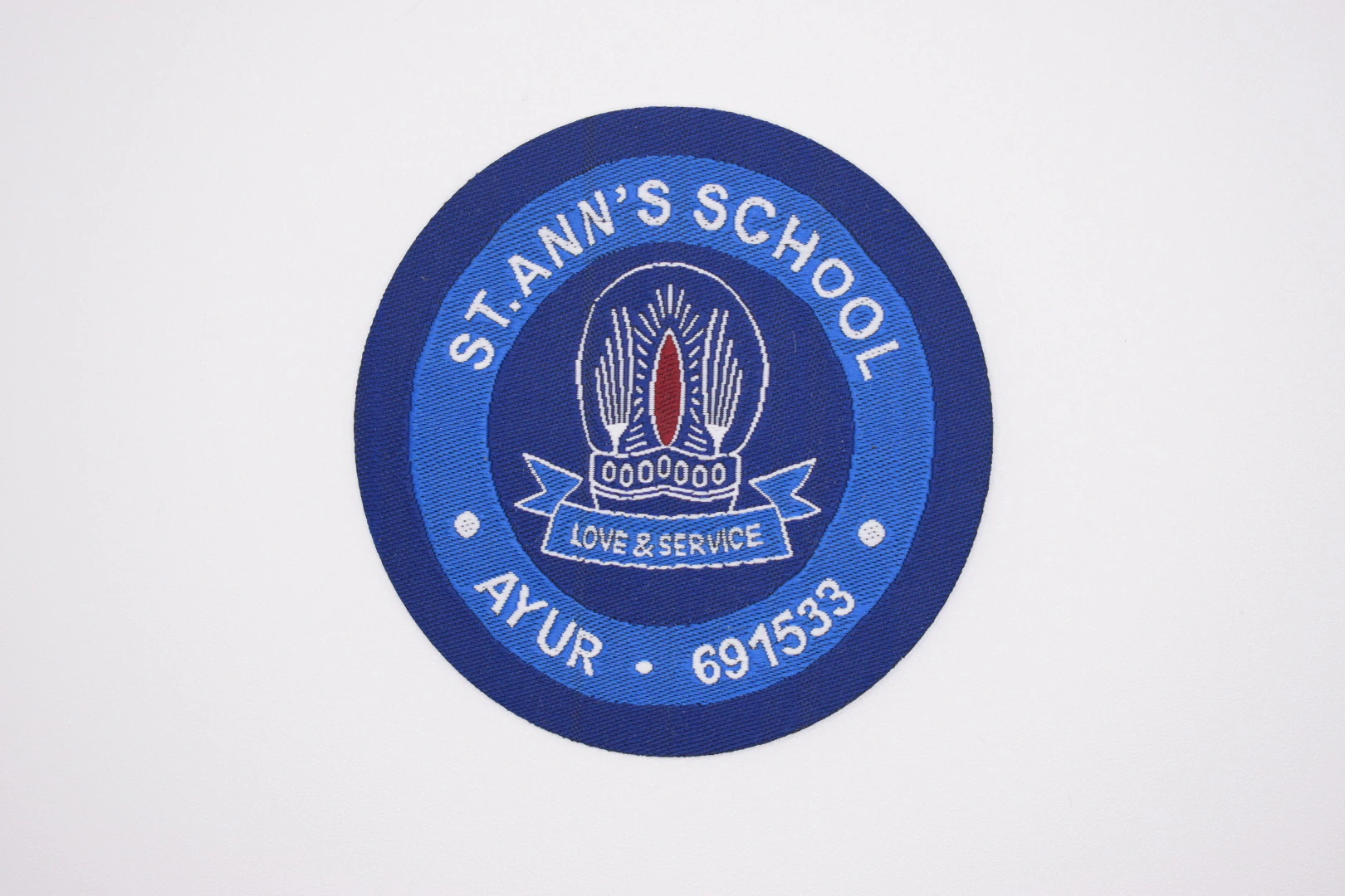 Stann's School die-cut woven uniform label — front view, school uniform label sample
